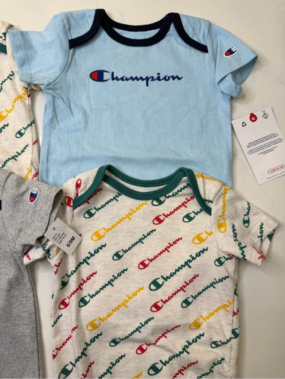 Champion 4-piece baby bodysuit bundle in size 6-9 months/9 months